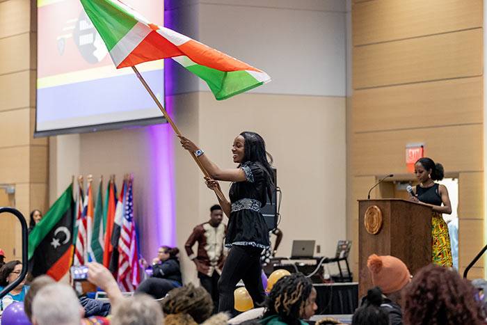 student waving flag at Africa Night event