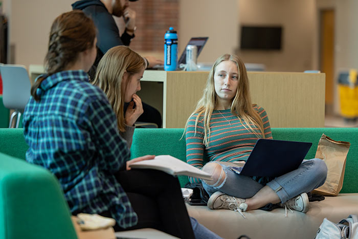 students collaborating on sofa in Union