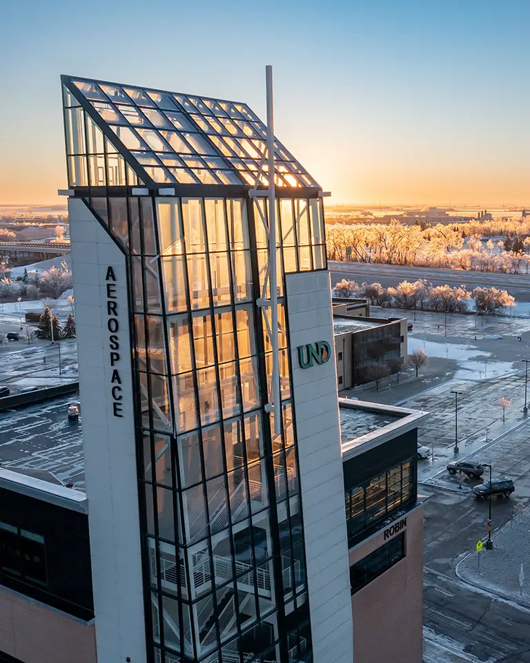 sun sets over the aerospace tower on campus