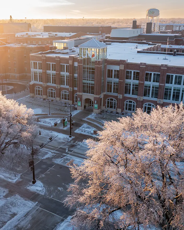 sunrises over a snowy Memorial Union