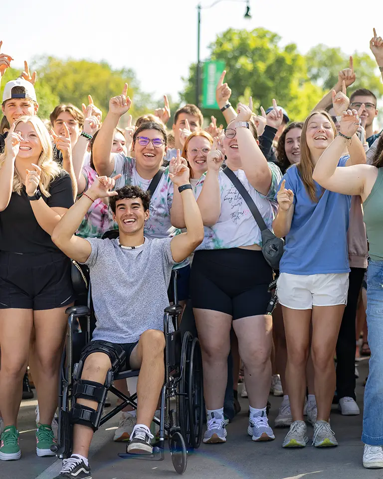 a group of student celebrate and dance