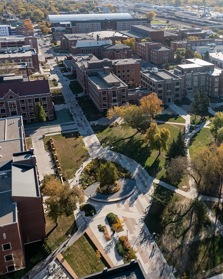 A drone photo shows the UND campus and walking path in the fall