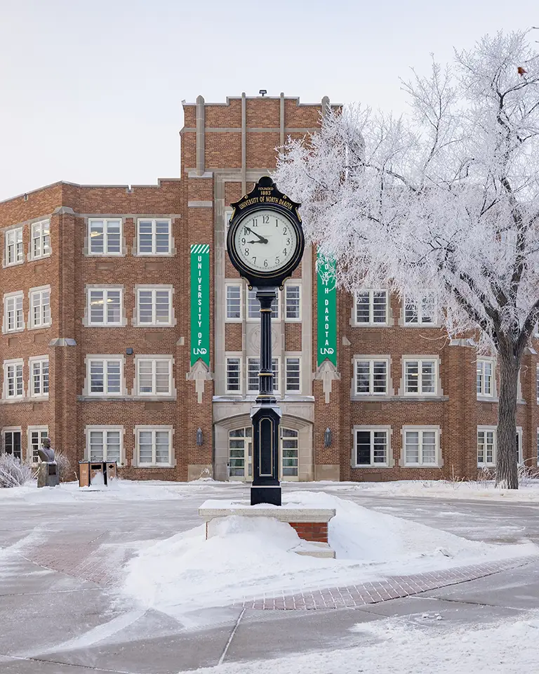 Twamley Hall stands out behind frosted trees on the quad.