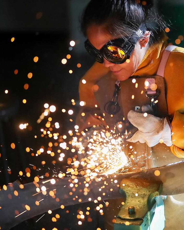 woman grinding metal