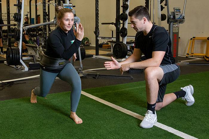man and woman working on strength training