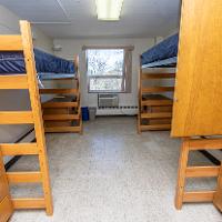 two closets, two lofted beds, two desks, and window
