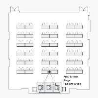 A ballroom filled with rows of tables and two chairs at each.