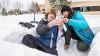 Professor and student perform atmospheric science experiments outside in snow 

