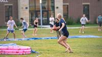 Students gather in Wilkerson Complex Quad outside of the Landing Zone for a game of Slip 'N Slide Kickball