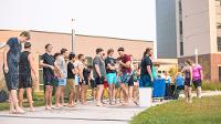 Students gather in Wilkerson Complex Quad outside of the Landing Zone for a game of Slip 'N Slide Kickball