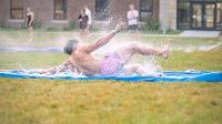 Students gather in Wilkerson Complex Quad outside of the Landing Zone for a game of Slip 'N Slide Kickball