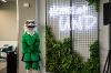 Large study room with a large greenery wall with the Fighting Hawk mascot next to a neon Home At UND sign