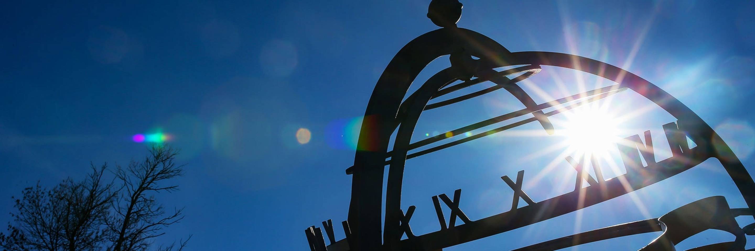 View of sky looking through globe sculpture located on UND's campus