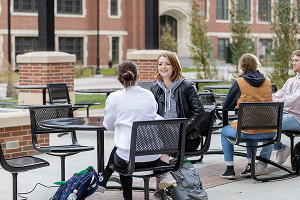 und students having coffee outside
