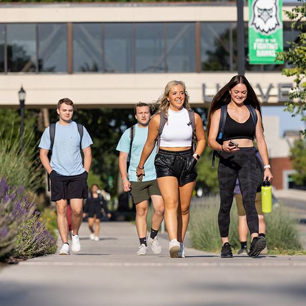 Students wallking on campus in summer