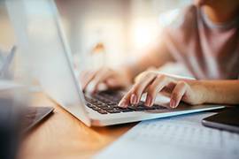 Student typing on a laptop