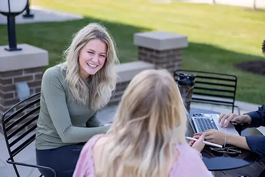 Students outside having a conversation