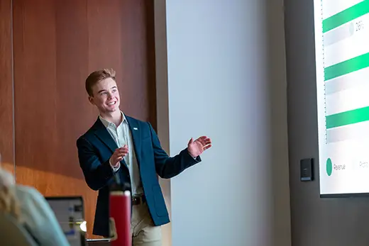 a student presenting in class in front of other classmates