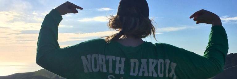 student by the ocean and mountains
