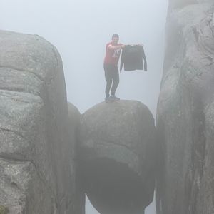 Student standing on rock