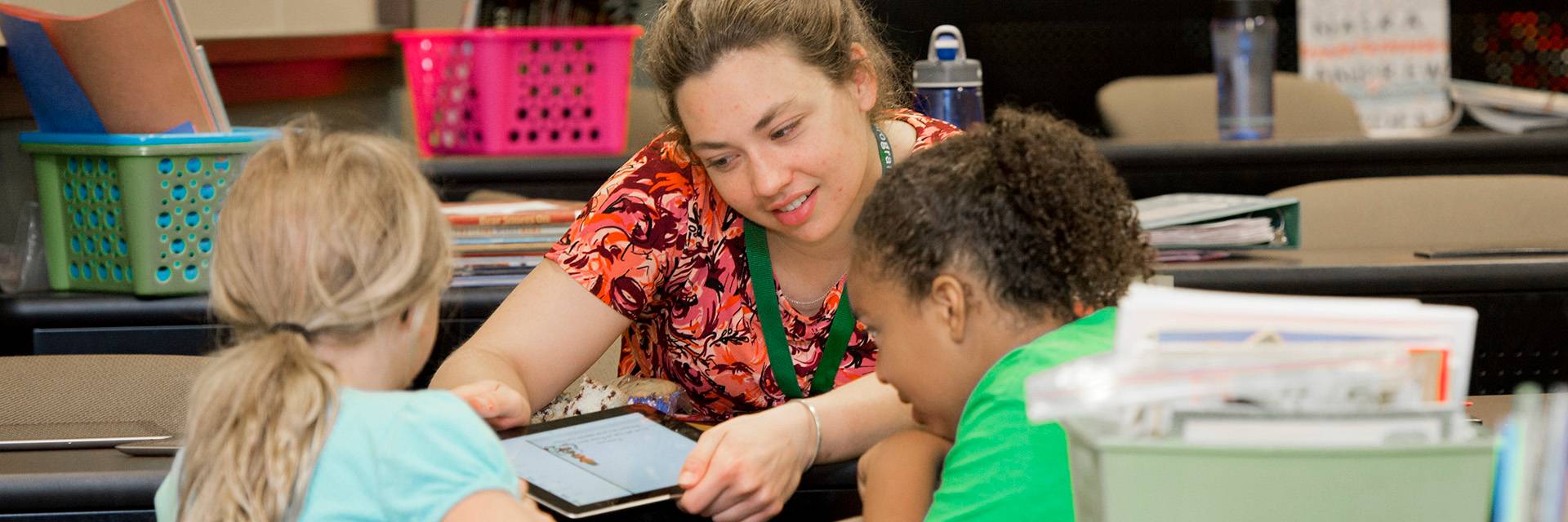 student reading camp student with children