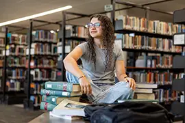 student studying in library