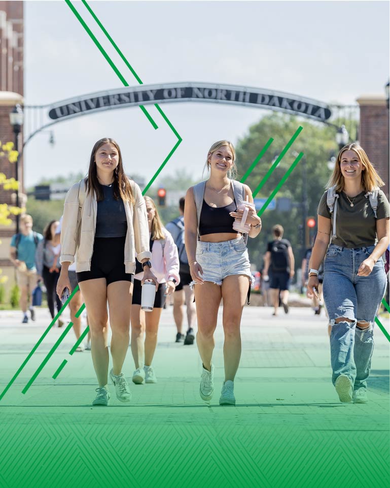 new transfer students walking by UND archway
