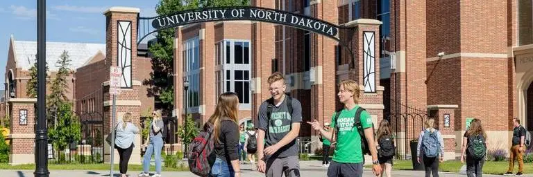 Students hanging out outside by the University of North Dakota arch