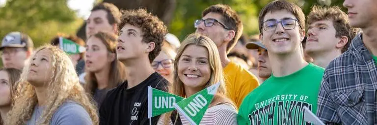 UND students smiling at camera during class photo