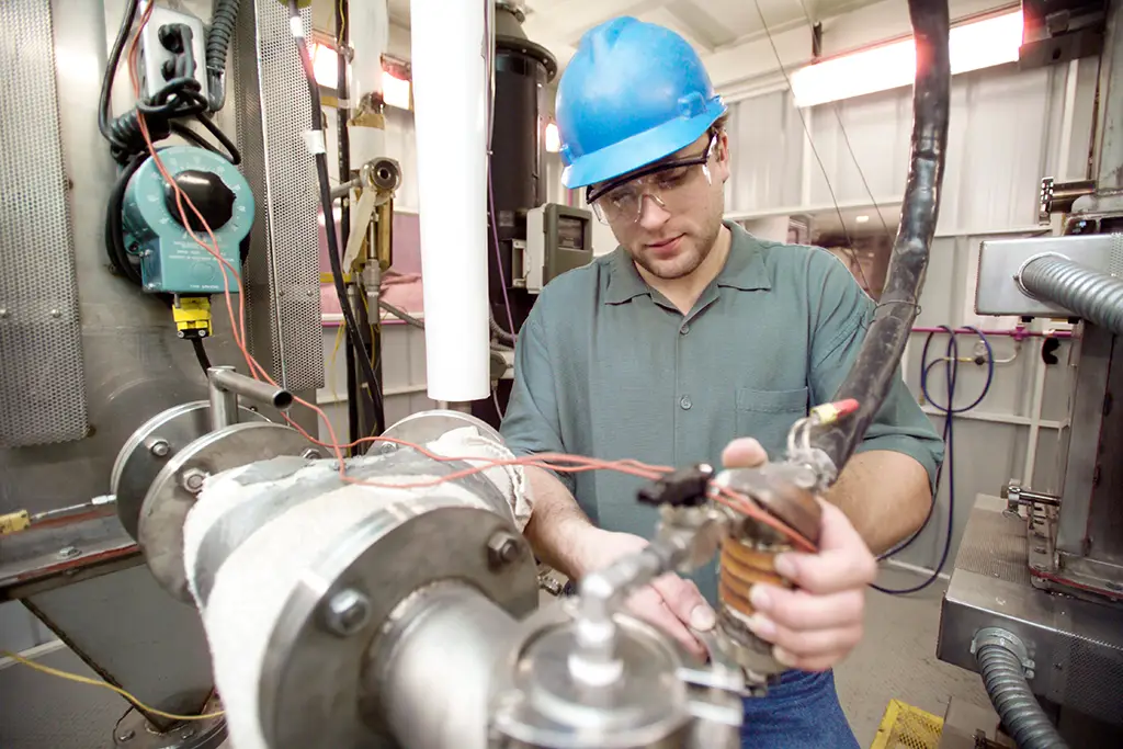 Hands on experience for an environmental engineering student performing maintenance and testing on an industrial process control system.