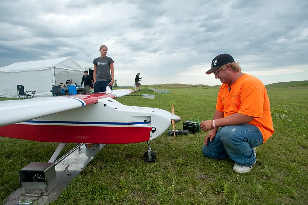 Mechanical engineering students conducting field testing of their Unmanned Aircraft System (UAS) design and build project.