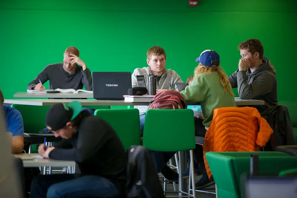 A diverse group of machine learning and statistics students studying together