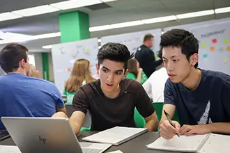 A diverse group of students working collaboratively on a data science project.