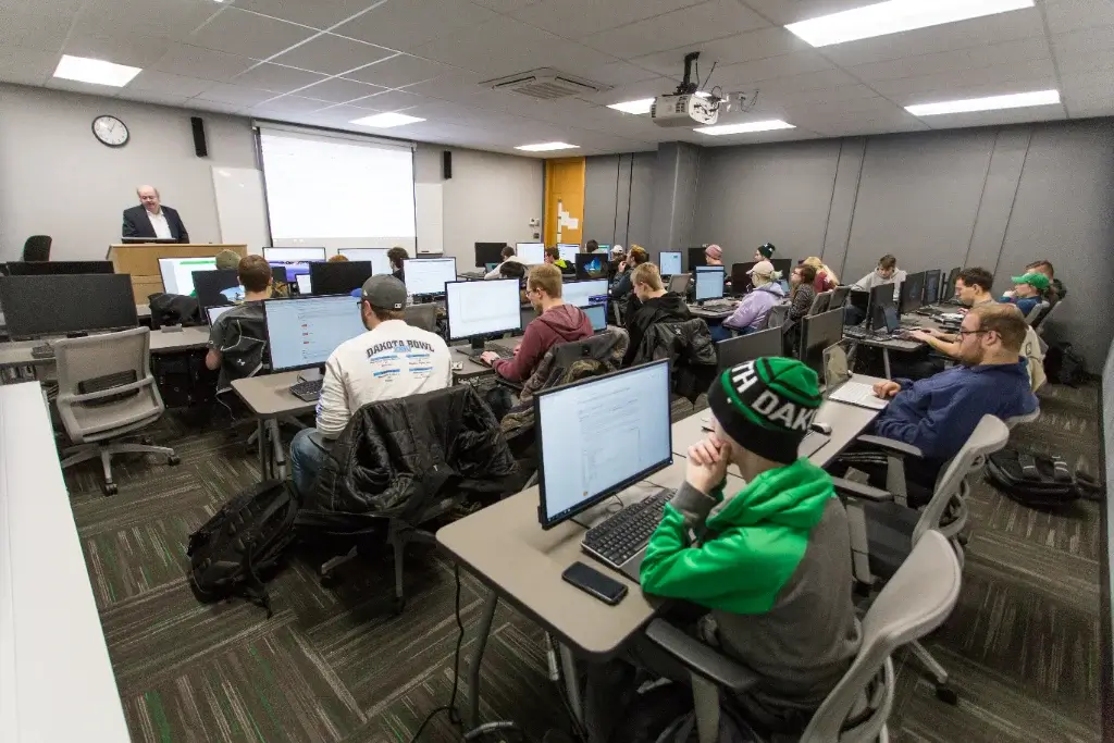 a cybersecurity class filled with students seated in front of their computers
