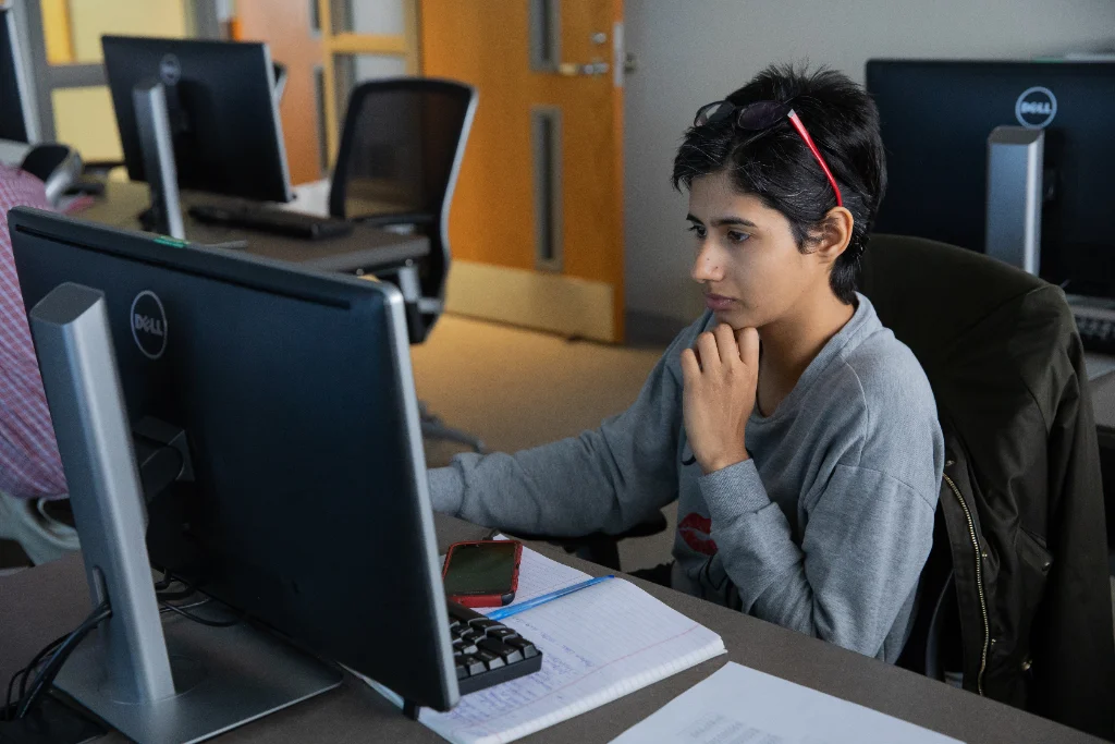 Student working on a computer in a data science library.