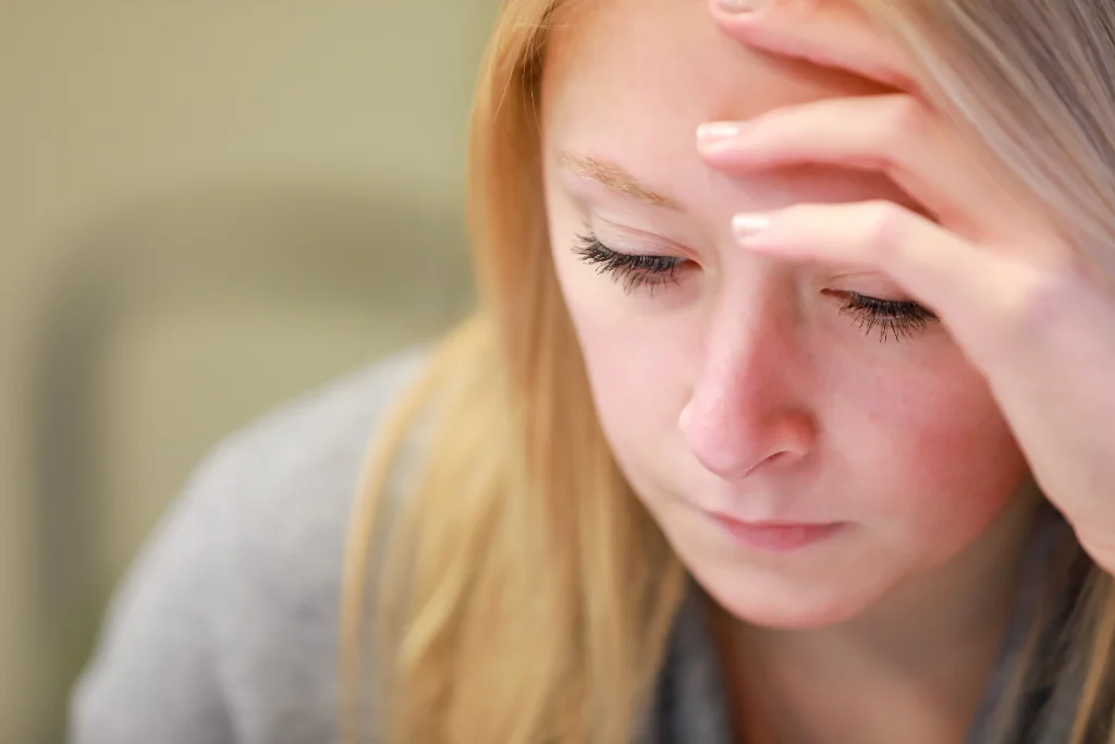 A female psychology student, absorbed in thought as she reads.