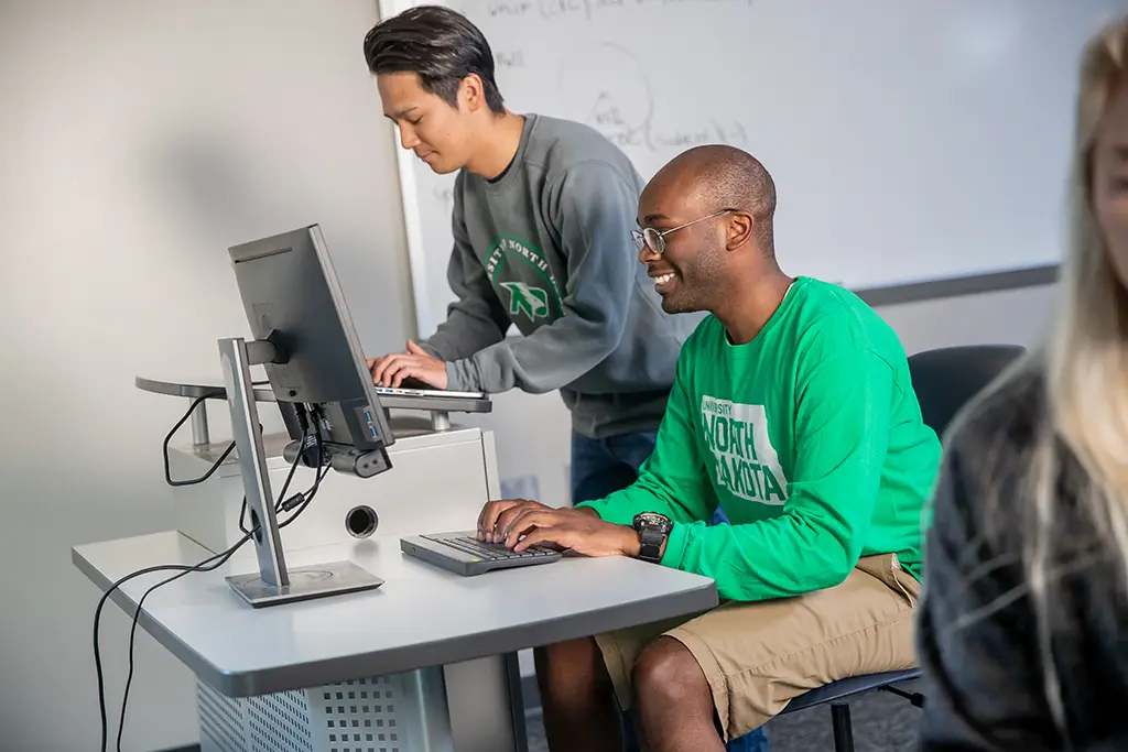 Two male students working at computers