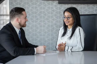 Business professionals engaged in conversation during a meeting.