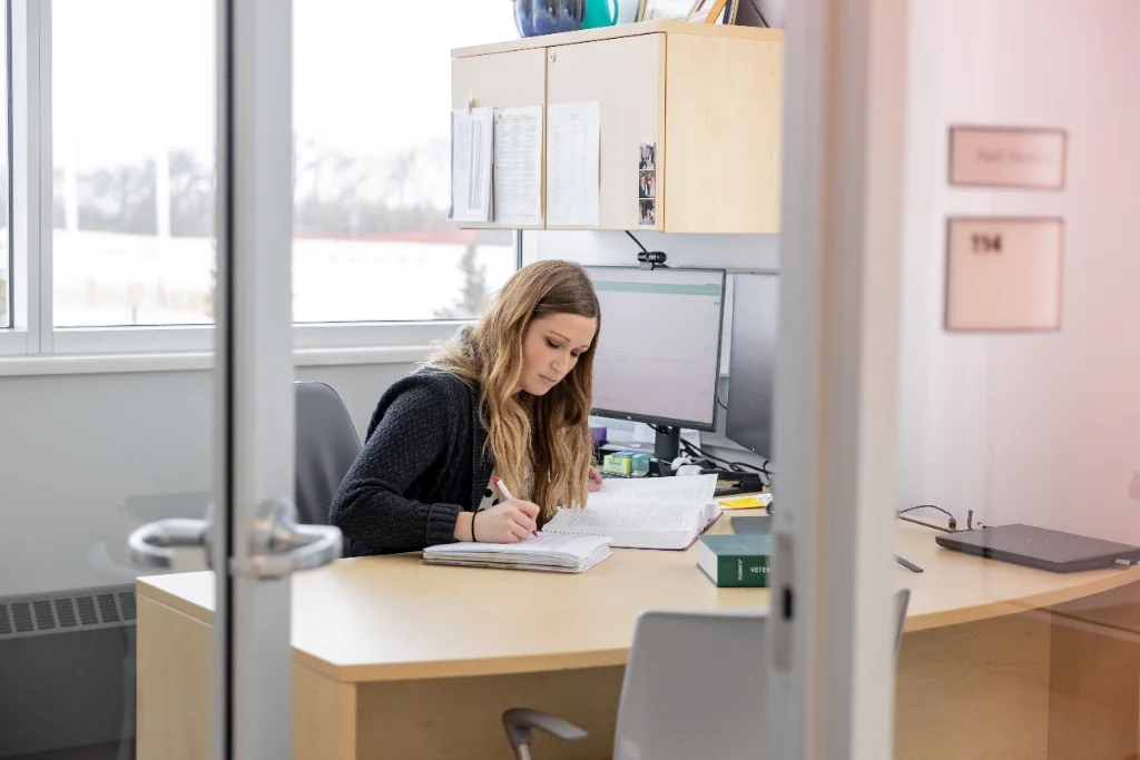 A female communication student working in an office