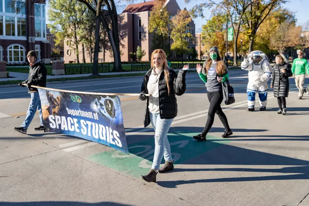 Students from the UND Space Studies Department marching in a parade.