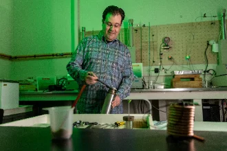 A geologist working in a lab, examining rock samples and conducting experiments.