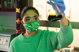 Students working in a lab utilize various techniques, such as chemical analysis.