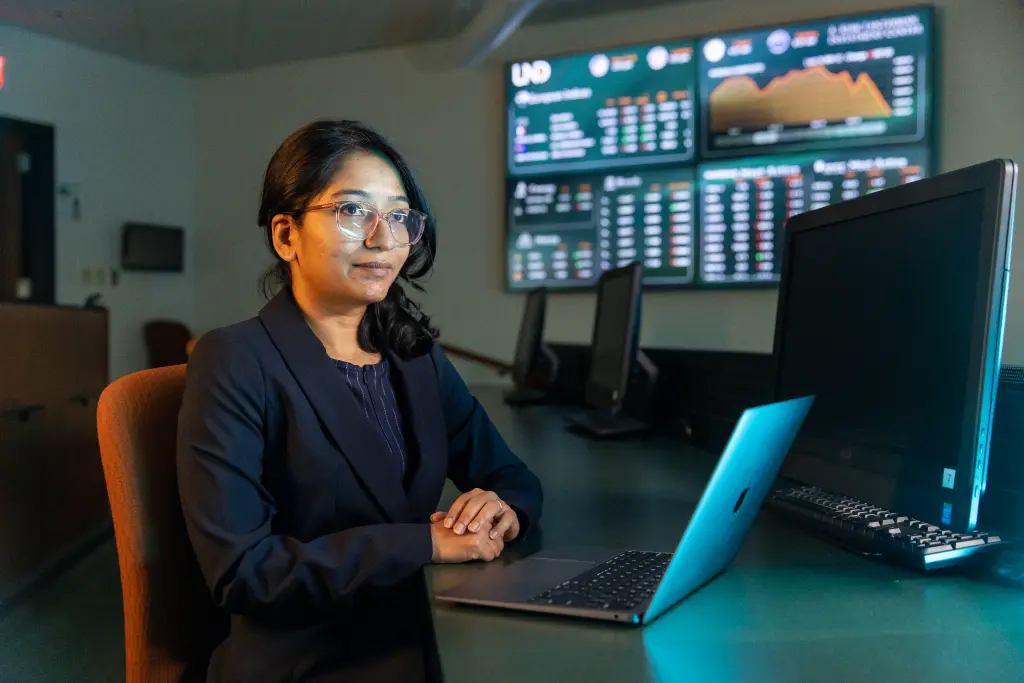 An applied economics student sitting attentively in a classroom, engaged in a lecture.