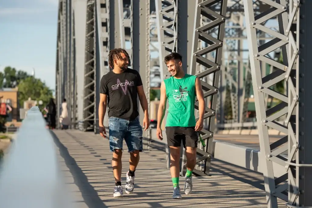 Two structural engineering students walking across a newly constructed bridge