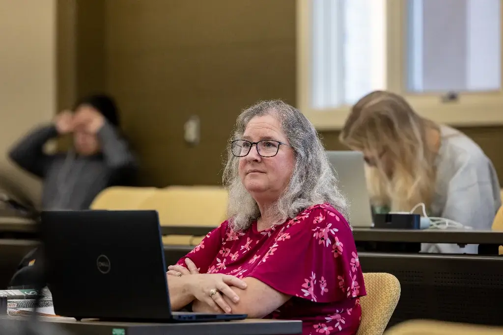 Criminal justice student listening attentively during a lecture.