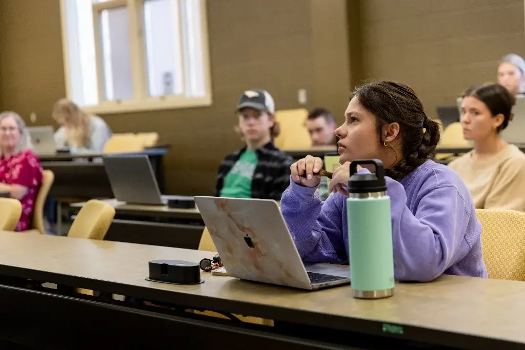 Criminal justice students focused on their professor during a classroom session.