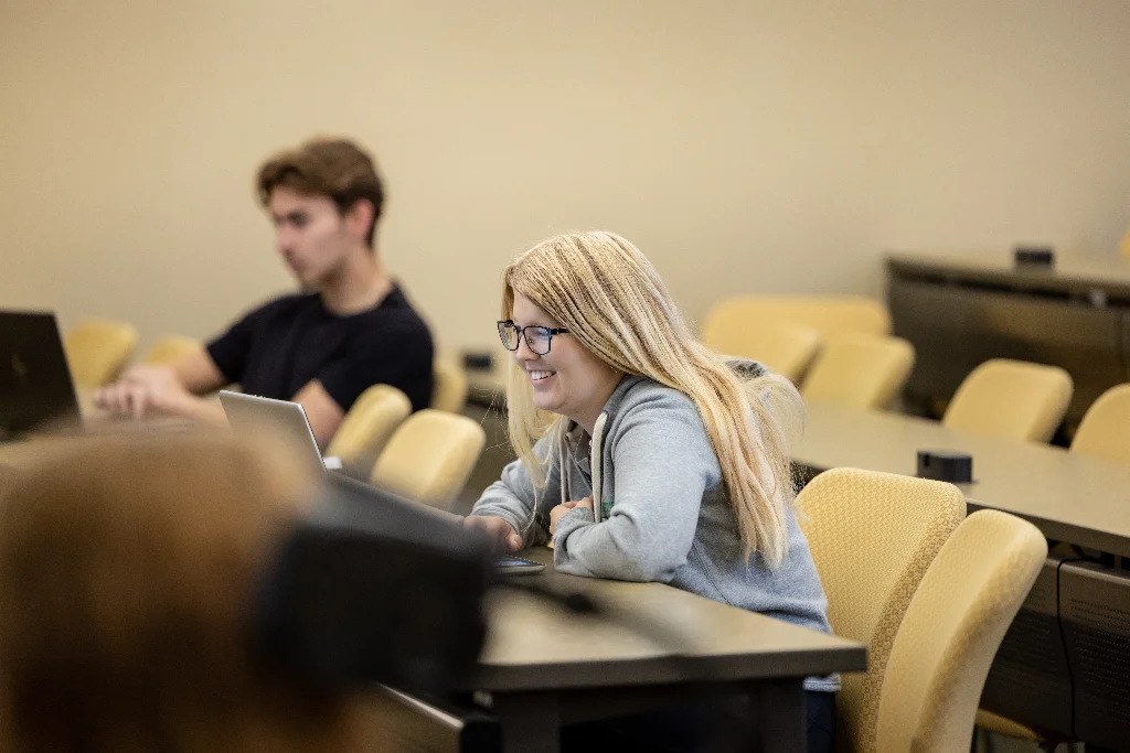 A female criminal justice student, attentively listening to the lecture