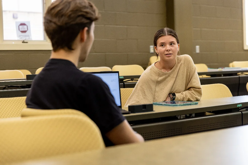 Two criminal justice students engaged in a discussion.