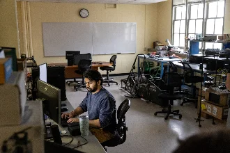 A cybersecurity student focused on solving real-world problems in class.