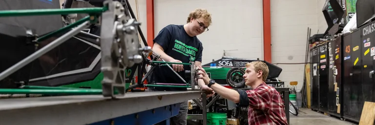 mechanical engineering students fixing a machine